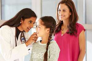 doctor with young patient and parent