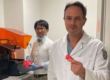 Dr. Perens and Takegawa Yoshida with a 3D model in the printer lab.