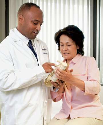 Langston T. Holly, MD speaking to patient