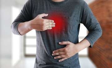 Man holding chest in pain