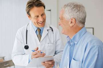 A doctor speaking with an older male patient
