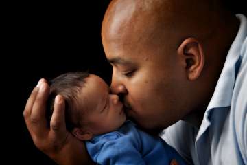 Father kissing baby