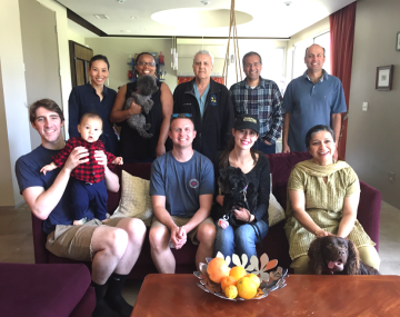 Thoracic Surgery Prospective Fellows, four sitting on a couch and a baby, and five standing behind them.