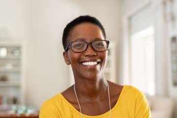 Smiling woman wearing yellow shirt