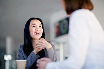 Woman laughing while speaking to a doctor