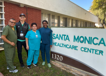 Four healthcare staff standing by Santa Monica Healthcare Center sign