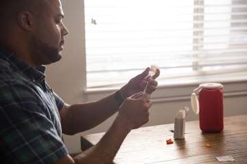 Man filling syringe of insulin