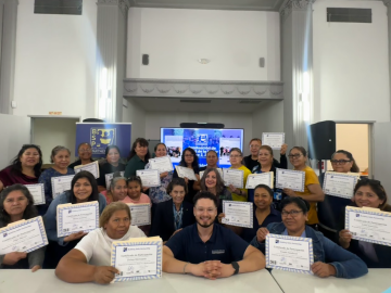 Group photo of graduates of IC-WHERC's Health Ambassador training holding paper certificateswith training facilitators