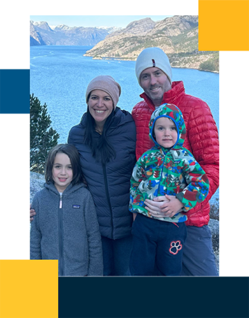 Errol Philip with family outdoors and lake in the background