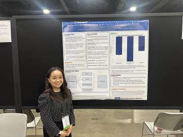Serinee standing in front of her research poster.