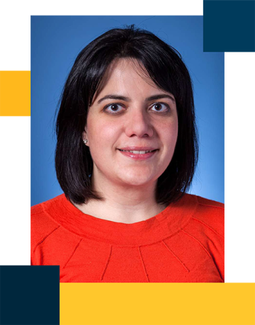 Dr. Rachel Brook wearing a white blouse in front of blue background