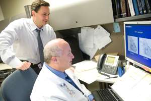 two doctors looking at a monitor