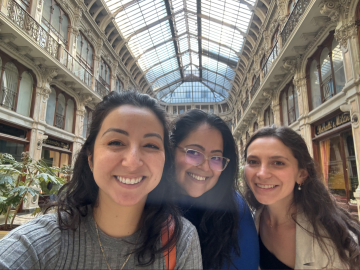 Norma, a peer, and their mentor taking a selfie in a room with a glass ceiling