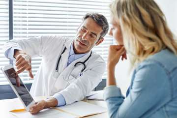 Doctor showing patient tablet