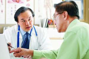 Two doctors speaking next to monitor