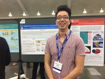 A fellow in front of his research presentation