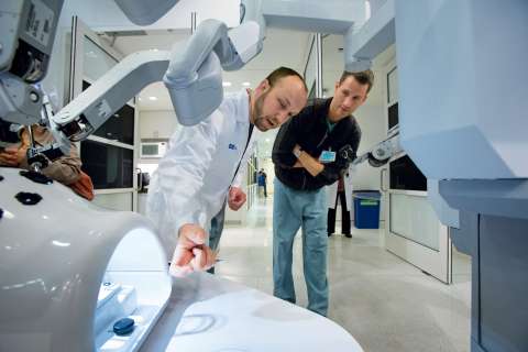 Doctors examining robot