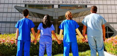 Nursing students holding hands