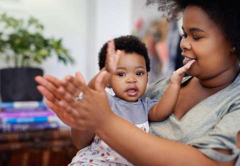 Mother and child clapping