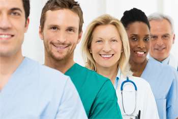 Group of nurses and doctors in a line smiling