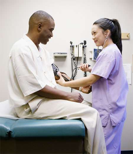 Nurse taking patient's blood pressure