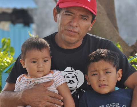 Man holding his two children