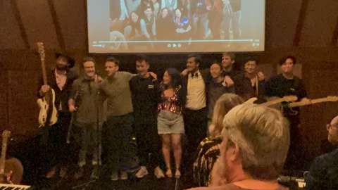 a band of Internal Medicine Residents taking a bow after performing in a cabin stage