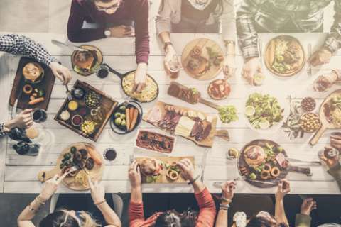 Large group of people sharing a meal at a table