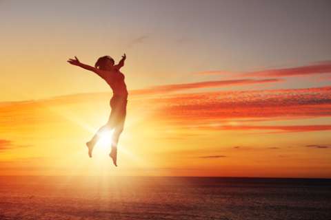 silhoutte of person jumping at the beach during sunset