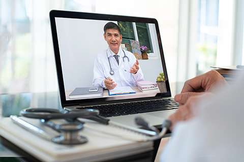 Telemedicine visit with doctor on laptop