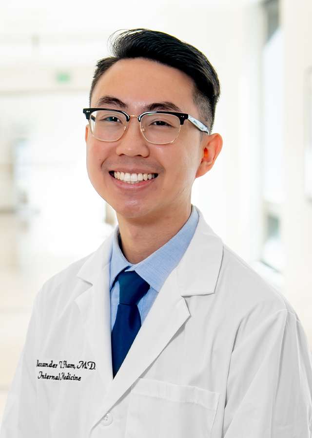 Headshot of Alex Pham, MD in a white Lab Coat