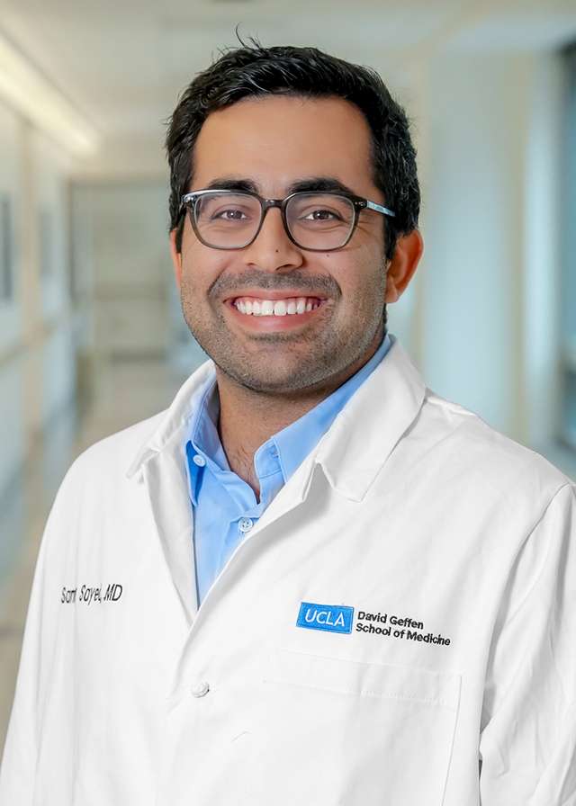 Headshot of Sammy Sayed, MD in a white Lab Coat