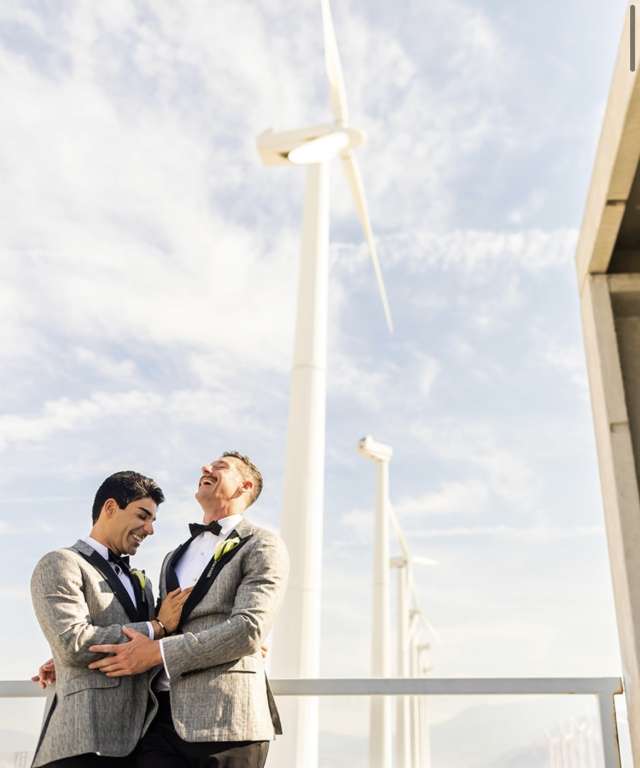 DAPM Dr. Dane Saksa and husband, Ryan, in front of windmills
