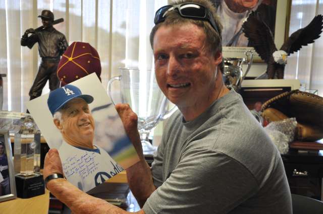 Joey holding up autograph from Tom Lasorda