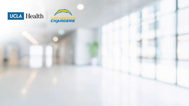 UCLA Health and Los Angeles Chargers logos displayed on a blurred, modern hospital hallway background.