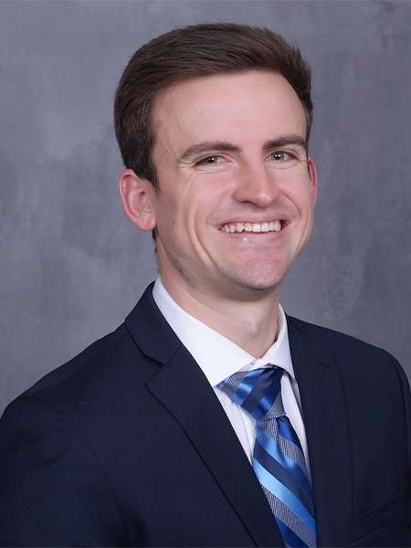 Dr. Ethan Wilson in a black suit