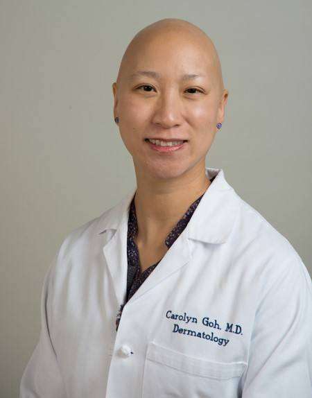 Portrait of Carolyn Goh, M.D. in a white lab coat, specializing in dermatology.