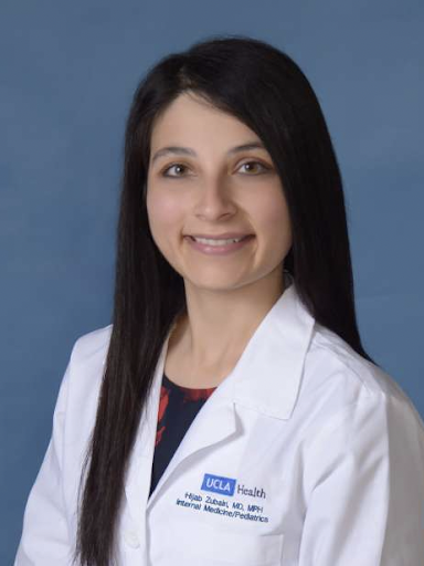 Dr. Hijab Zubairi headshot, smiling and wearing her lab coat.