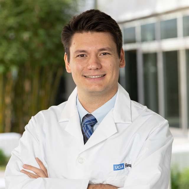 Christian De Caro, PhD standing outside with a friendly smile at UCLA Health.