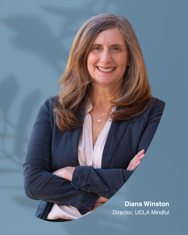 A woman, Diana Winston, with long brown hair in a blazer and blouse stands with arms crossed, smiling. Text reads: "Diana Winston, Director, UCLA Mindful." Blue background with leaf shadow.