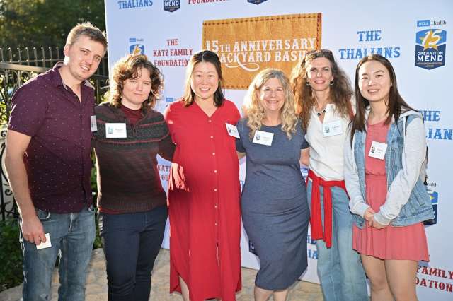 People posing during the Operation Mend 15th Anniversary Backyard Bash