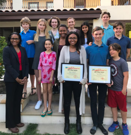 Two students posing in front of a group while receiving the Luca-Kaycee Award.
