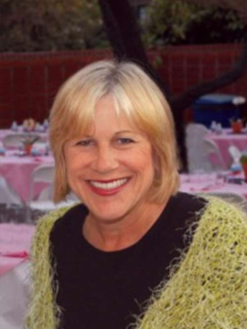 Headshot of Cathy Hession smiling in an outdoor setting