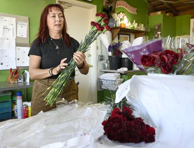 Anita MacDonald prepares a floral arrangement