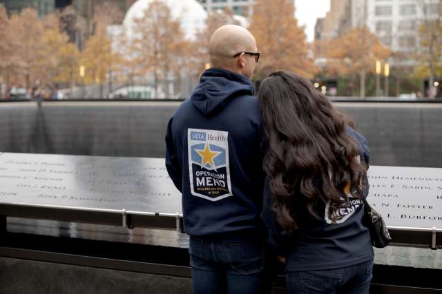 A couple wearing Operation Mend jackets at the 9/11 museum