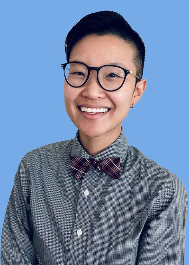 Headshot of Dr. Esther Kang wearing glasses and a button shirt with bowtie