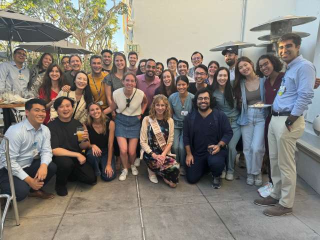 a large group of Internal Medicine Residents posing with Dr. Skinner for her birthday