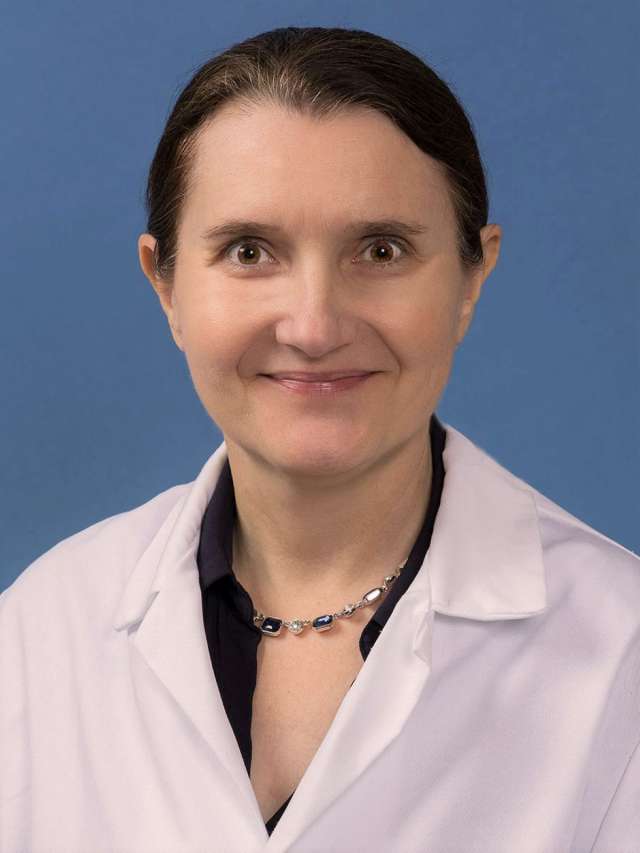 Sandra Orsulic, PhD in a white lab coat