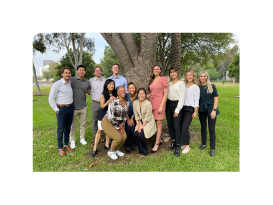 group of PM and R residency program residents outside near a tree
