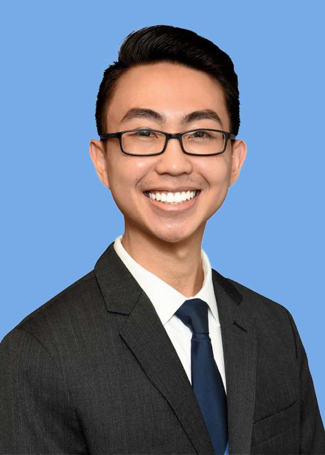 Headshot of Dr. Alexander Pham in a black suit and tie